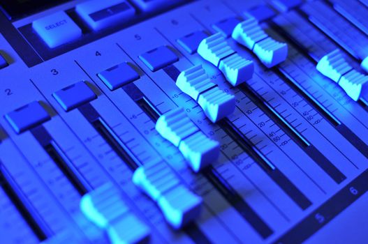 Mixing console illuminated by blue light