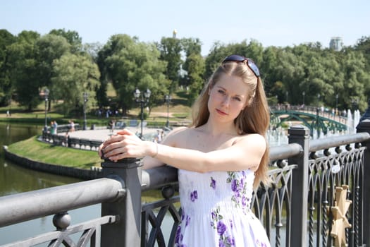 Pretty blond girl at the city park on a summer day