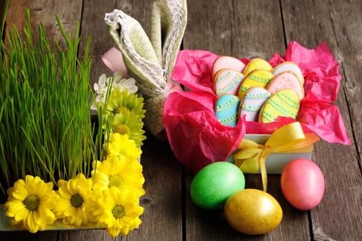 Easter homemade gingerbread cookie and eggs over wooden table