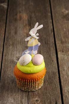 Easter homemade cupcake over wooden table