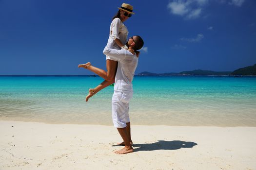 Couple in white on a tropical beach