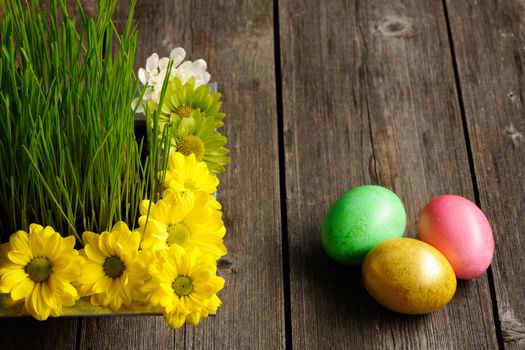 Colored easter eggs on wooden table