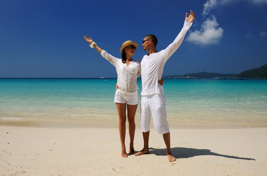 Couple in white on a tropical beach