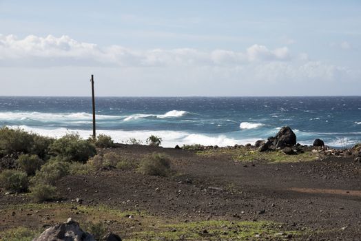 coastline tenerife with dry land and waves on the water