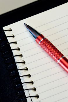 Red ballpoint on a blank paper with lines