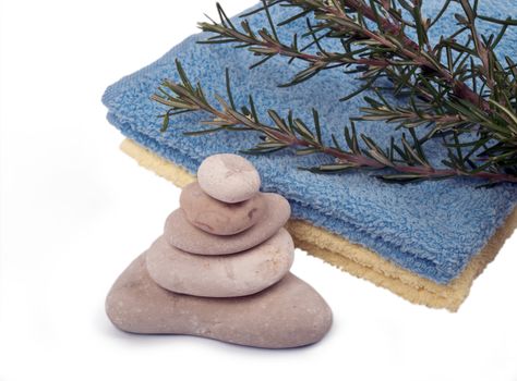 balanced sea stones, towels and rosemary