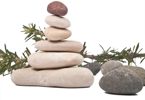 dark rocks, balanced rocks and branch of rosemary