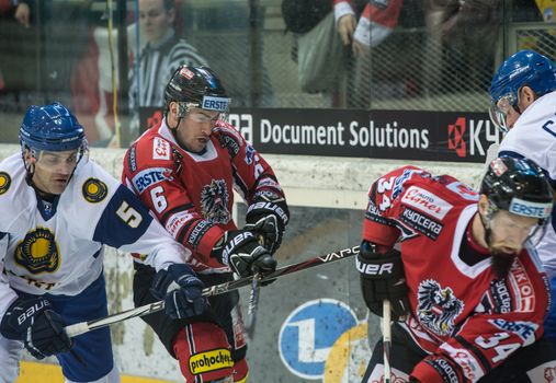 VIENNA - FEB 3: International hockey game between Austria and Kazakhstan. Tough battle at the boards between Raphael Rotter and Yevgeni Blokhin on February 3, 2013 at Albert Schultz Halle in Vienna, Austria.