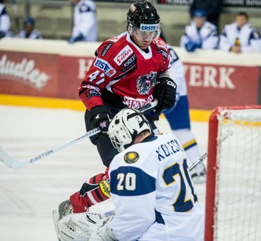 VIENNA - FEB 3: International hockey game between Austria and Kazakhstan. Vitali Kolesnik makes the save against Martin Ulmer on February 3, 2013 at Albert Schultz Halle in Vienna, Austria.