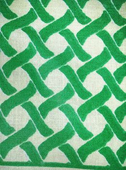 Bold graphic fabric made of woven green and white, or beige, cotton, great textile for arts and crafts background.