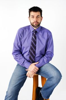 Middle aged caucasian man with short beard posing for photographer in studio over white background, can be actor or dating service.
