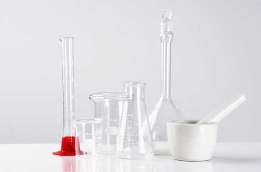 Science concept: empty laboratory glassware over light background,sterile look.