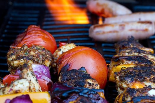 chicken and pepper kebabs slowly cooking on the barbecue