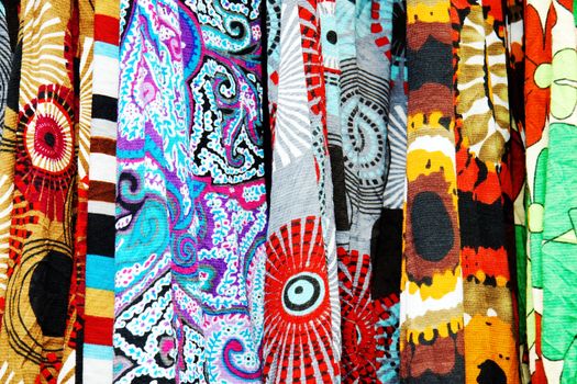 Serie of textile fabric samples, all with bold ethnic graphics and designs, great colorful background with varying depth of fields.