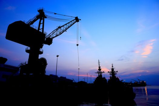 Cranes in dockside at sunset