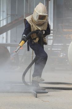 Sandblasting of metal structures at construction site