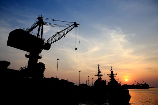 Cranes in dockside at sunset
