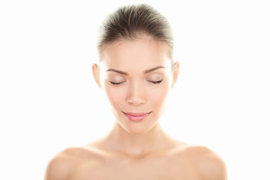 Beauty woman portrait. Skin and beauty care concept with beautiful serene multiracial woman closing eyes relaxing isolated on white background in studio. Mixed race Caucasian / Asian Chinese female beauty model relaxed.