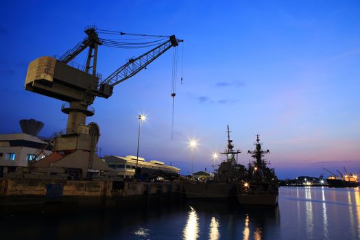 Cranes in dockside at sunset