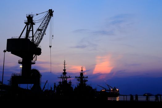 Cranes in dockside at sunset