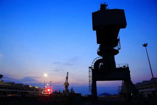Cranes in dockside at sunset