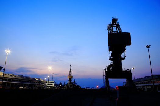 Cranes in dockside at sunset