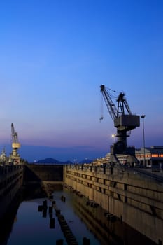 Crane near a covered dry dock at the shipyard