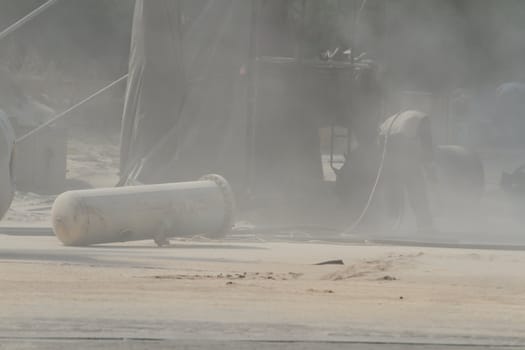Sandblasting of metal structures at construction site