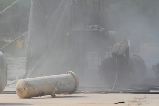 Sandblasting of metal structures at construction site