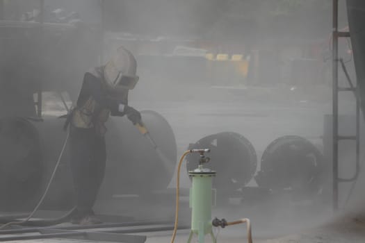 Sandblasting of metal structures at construction site