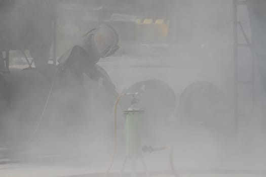 Sandblasting of metal structures at construction site