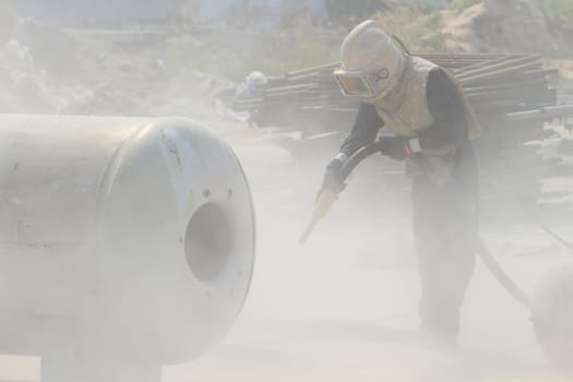 Sandblasting of metal structures at construction site