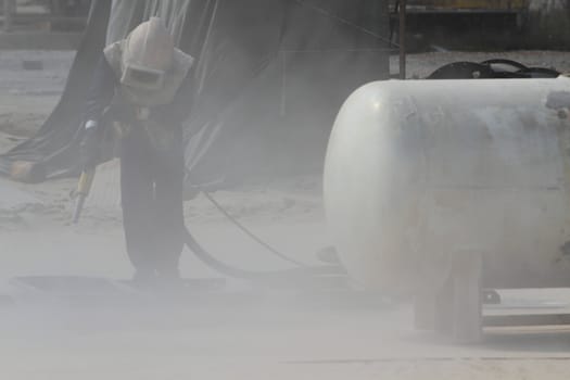Sandblasting of metal structures at construction site