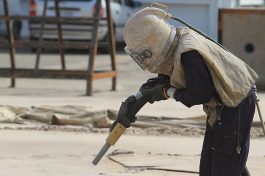 Sandblasting of metal structures at construction site