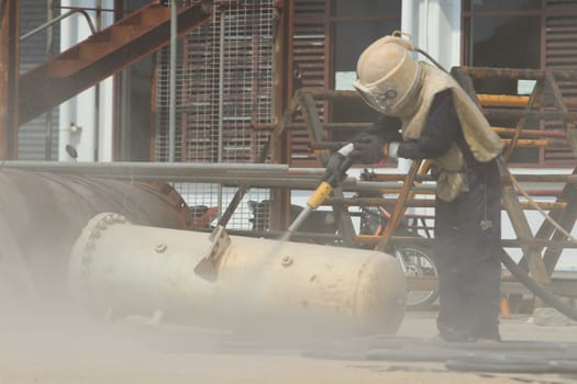 Sandblasting of metal structures at construction site