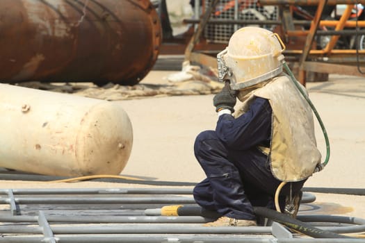 Sandblasting of metal structures at construction site