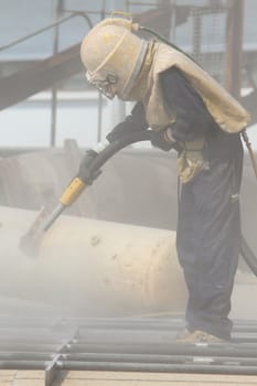 Sandblasting of metal structures at construction site