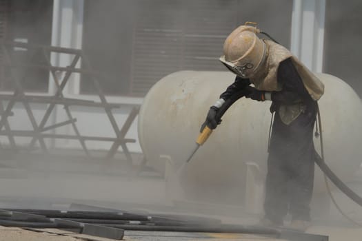 Sandblasting of metal structures at construction site