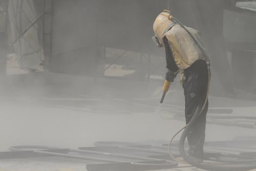 Sandblasting of metal structures at construction site
