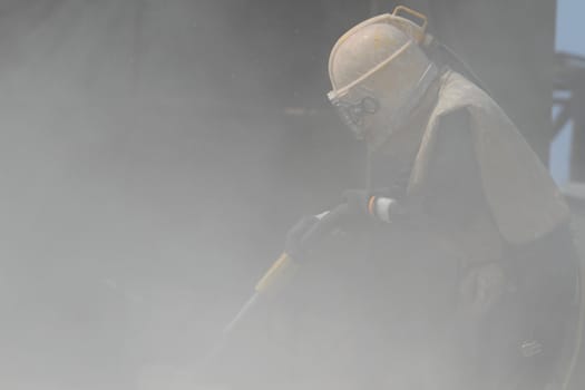 Sandblasting of metal structures at construction site