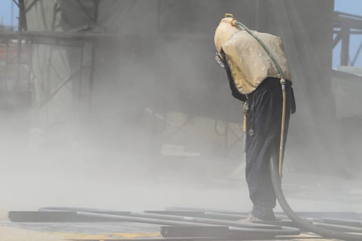 Sandblasting of metal structures at construction site