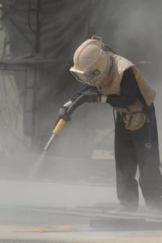 Sandblasting of metal structures at construction site