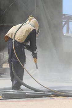 Sandblasting of metal structures at construction site