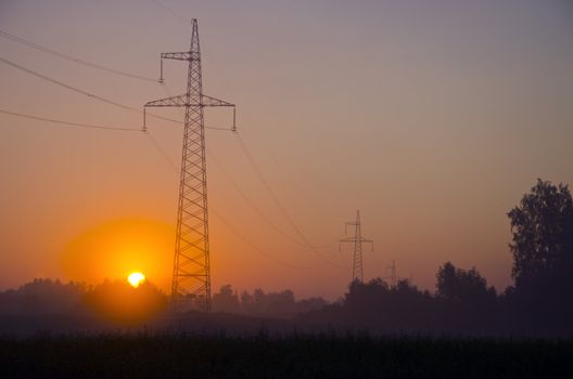 morning landscape with electricity transmission towers and sunrise 