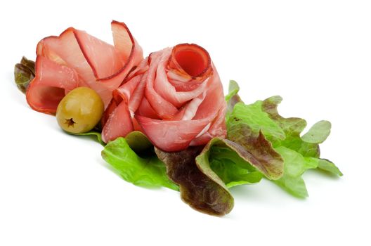 Curling Slices of Prosciutto on Lettuce Romano with Green Olive isolated on white background