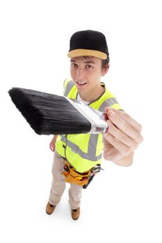 Young male apprentice holding a paintbrush ready for your message.  White background.