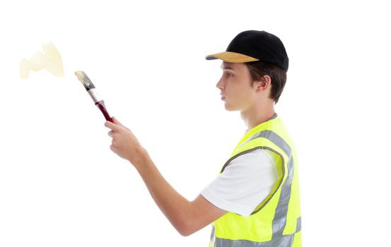 A young apprentice handyman painter applying some paint.  White background.