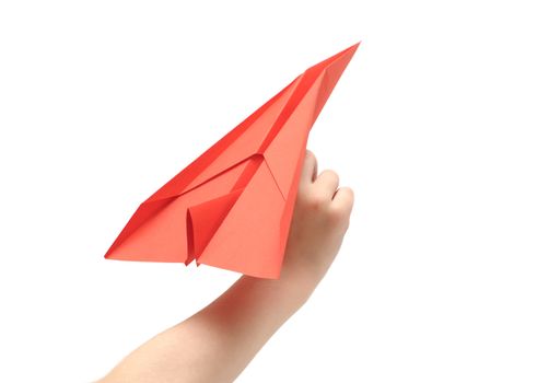 Child's hand launching paper airplane