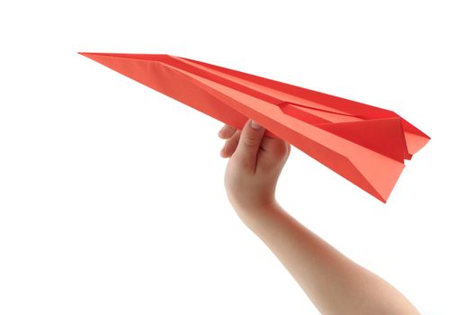 Child's hand launching paper airplane