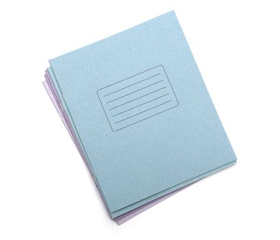 multicolored exercise books over the white background